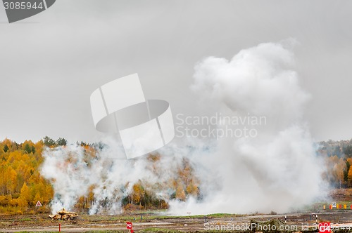 Image of Russian tank T-90 hides in smoke screen from enemy