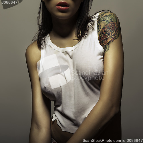 Image of tattoo girl in wet t-shirt