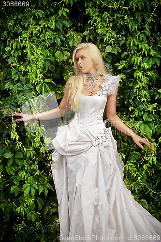 Image of attractive blonde bride in luxury clothes