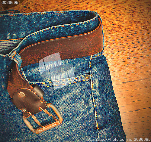 Image of blue jeans with a leather belt