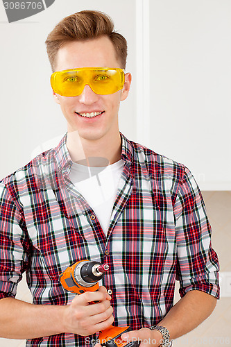 Image of smiling repairman with a dril