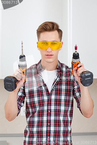 Image of master with screwdriver and drill 