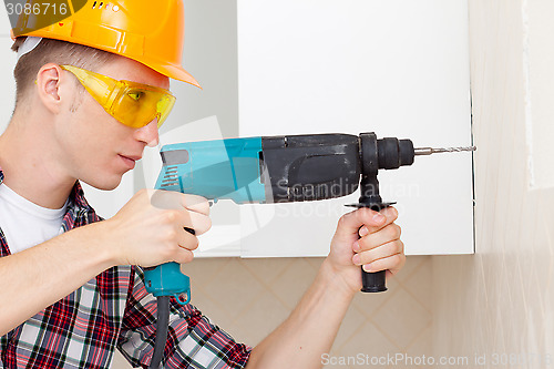 Image of worker with drill