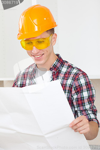 Image of smiling architect  with repair plan