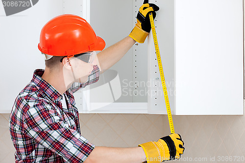 Image of worker with a tape measure