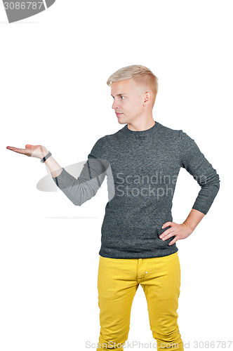 Image of Young handsome man holding something