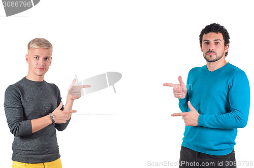 Image of Two handsome guys showing somewhere with fingers