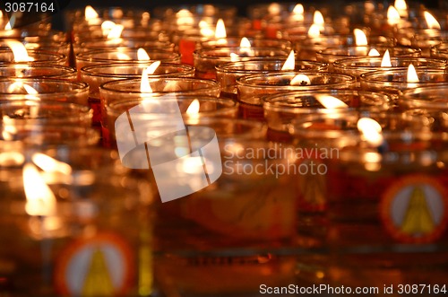 Image of Burning candles in a temple for worship.