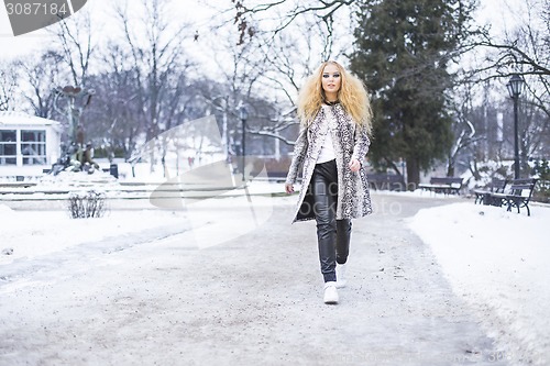 Image of Blonde girl in the park on a winter day