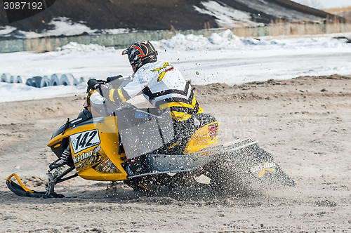 Image of Snowmobile rider on sport track