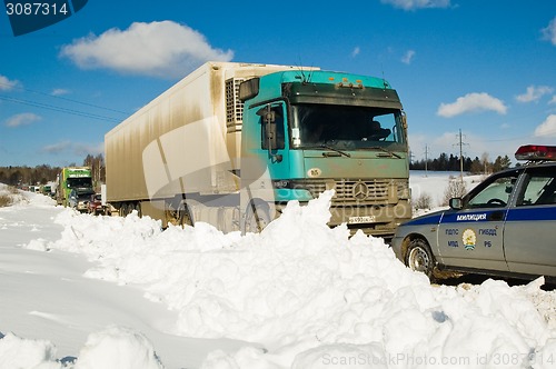 Image of Trucks stopped on highway after heavy snow storm