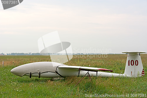 Image of White glider on the airfield.