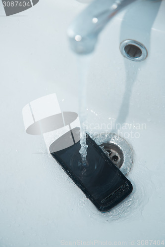 Image of Smartphone in sink with flowing water