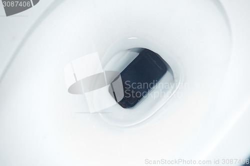 Image of Smartphone dropped to the toilet bowl