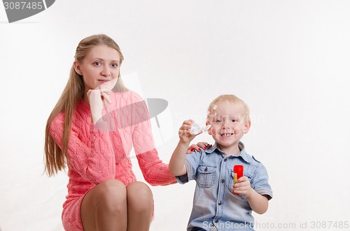 Image of Mom and son blow bubbles