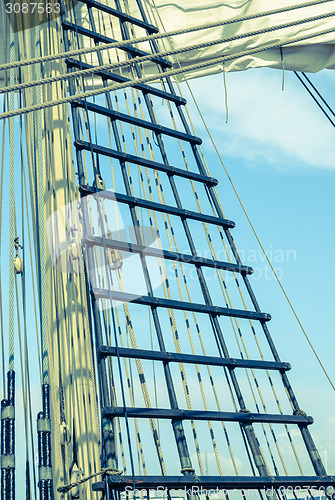 Image of Sails and tackles of a sailing vessel on a background of the sky