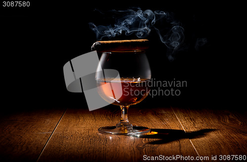 Image of Cigar on wineglass