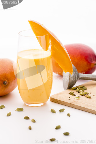 Image of Decorated Mango Milk Shake And Crushed Cardamon