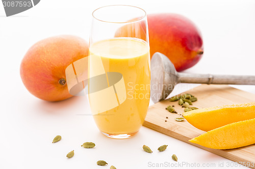 Image of Mango Milkshake, Two Mangos And Fruit Slices