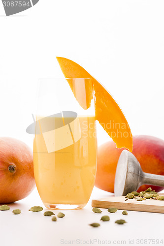 Image of Glass Of Mango Smoothie Decorated With Fruit Slice