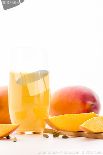 Image of Glass Of Mango Lassi And Cut Fruit Pulp On White