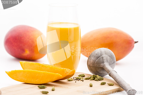 Image of Crushed Cardamon, Pestle, Mangos And Mango Lassie