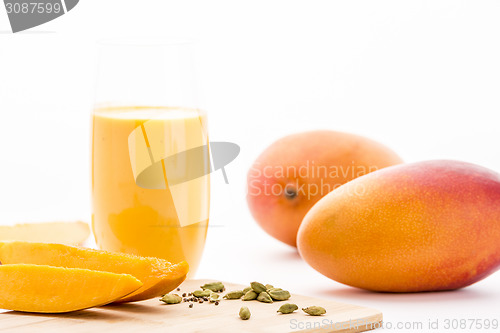 Image of Mangos, Cardamon And Mango Yoghurt Drink On White