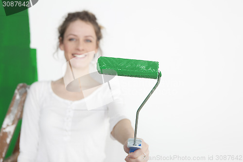 Image of Woman with green paint roller