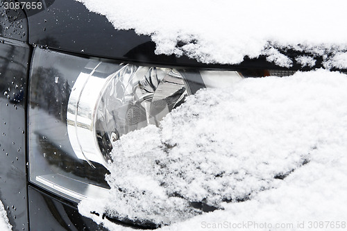 Image of Snowed car headlights in winter