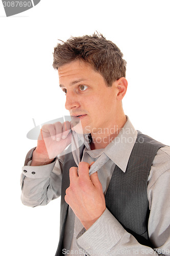 Image of Man taking his tie of.