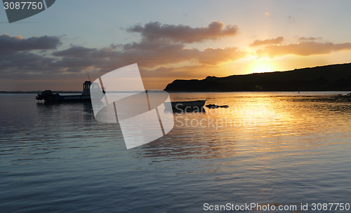 Image of Boats on the water at sunrise