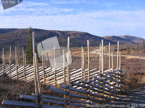 Image of Traditional Norwegian fence (skigard) with mountains in the background