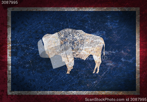 Image of Old rusty metal sign with a flag