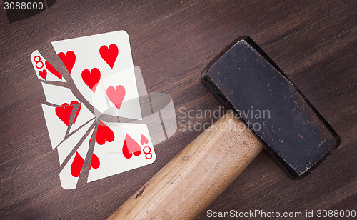 Image of Hammer with a broken card, eight of hearts