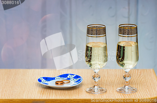 Image of Two champagne flute filled with champagne.