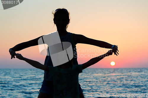 Image of Silhouette of a young woman and child on the background of the e
