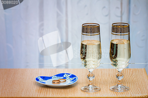 Image of Two champagne flute filled with champagne.