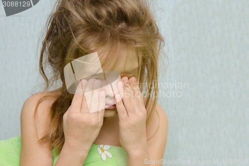 Image of Awakened girl rubbing sleepy eyes