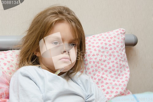 Image of Six year old girl in bed temperature of 