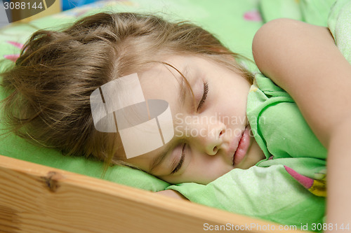 Image of Portrait of young girl sleeping in bed