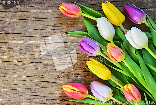 Image of bouquet of colorful tulips over rustic wooden