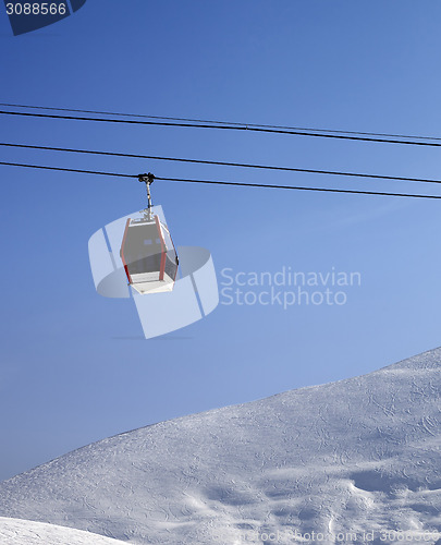 Image of Gondola lift and off piste slope at sun morning