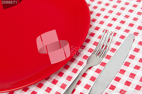 Image of Red plate and cutlery