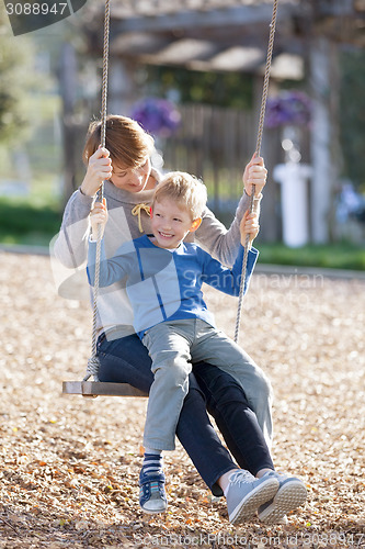 Image of family at swings