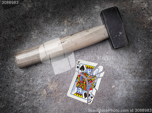 Image of Hammer with a broken card, king of spades