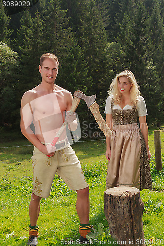Image of Bavarian couple in the work of firewood