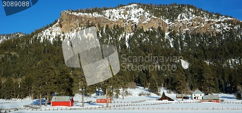 Image of Red house under the snow mountain in the winter
