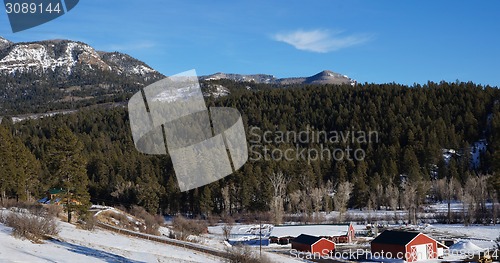 Image of Red house under the snow mountain in the winter