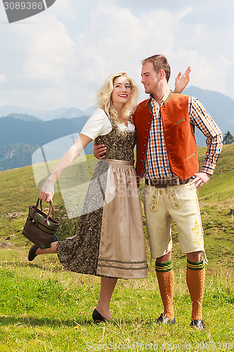 Image of Bavarian couple in fashionable leather pants and dirndl