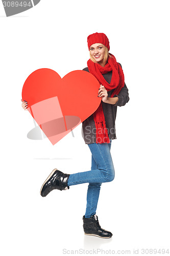 Image of Full length girl holding up a red cardboard heart